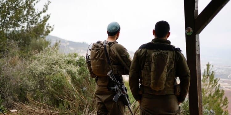 Israeli soldiers take a position along the Israel-Lebanon border on March 7, 2026.
