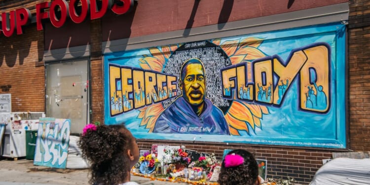 Jordan and Royal Pacheco learn of George Floyd's murder at the intersection of 38th Street and Chicago Avenue, ahead of former Minneapolis police officer Derek Chauvin's sentencing, on June 25, 2021, in Minneapolis, Minnesota.