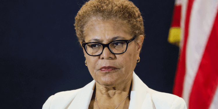Karen Bass stands with a straight face.
