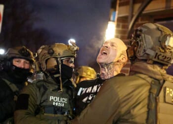 Federal agents with Homeland Security Investigations detain a protestor wearing an "Antifa" shirt outside a residential building in Minneapolis, Minnesota, on Feb. 5, 2026.