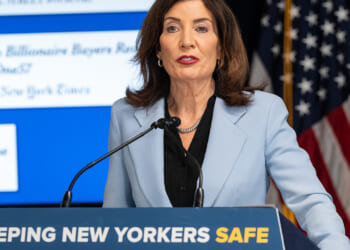Kathy Hochul Speaking Behind a Podium that Says "Keeping New Yorkers Safe"