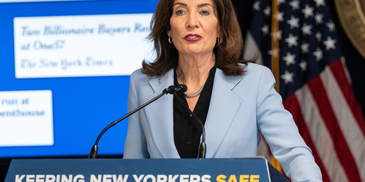 Kathy Hochul Speaking Behind a Podium that Says "Keeping New Yorkers Safe"