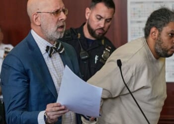 Randy Santos is humped over in a New York City Courtroom as an accompanying attorney argues to the court on May 28, 2026.