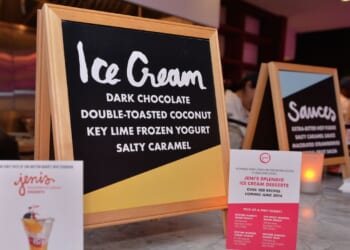 Signs advertise ice cream at a food festival.