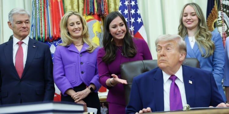 President Donald Trump listens as Sen. Katie Britt delivers remarks during an event on maternal healthcare in the Oval Office of the White House on May 11, 2026, in Washington, D.C.