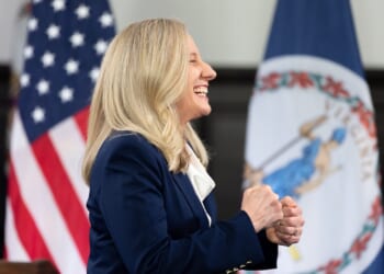 Virginia Gov. Abigail Spanberger stands smiling.