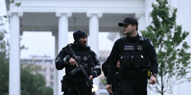 Secret Service agents are seen after a lockdown was lifted at the White House in Washington, D.C., on May 23, 2026.
