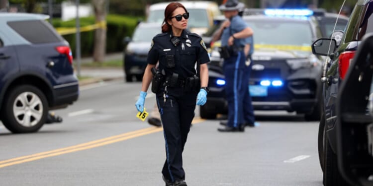 An officer walks on the scene of the Cambridge, Massachusetts incident.