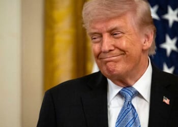 President Trump stands and smiles in the East Room in the White House on May 4, 2026.