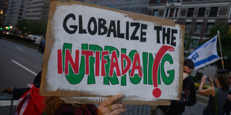 Sign reading "Globalize the Intifada"