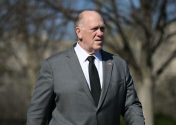 White House Border Czar Tom Homan walks on the White House grounds as journalists wait for President Donald Trump to return from Dover Air Force Base in Delaware after attending a dignified transfer solemn event on March 18, 2026.