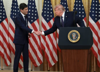 Kevin Warsh and Donald Trump shake hands