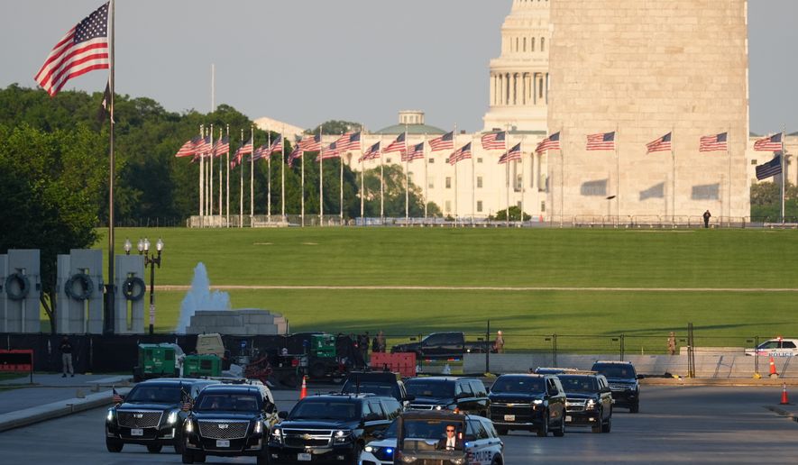 The motorcade with President Donald Trump drives in the Lincoln Memorial Reflecting Pool as he arrives to to see the new blue protective coating being applied as part of a renovation project, Thursday, May 7, 2026, in Washington. (AP Photo/Mark Schiefelbein)