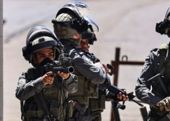 A member of the Israeli security forces aims his weapon while patrolling during a military raid in the Qalandia refugee camp, south of Ramallah in the Israeli-occupied West Bank, on May 11, 2026.