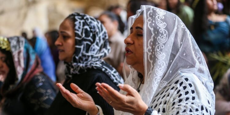 Coptic Christians attend a Palm Sunday Mass at the Monastery of Simon the Tanner in Cairo, Egypt, on April 5, 2026.