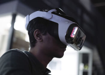 A man wears a virtual reality headset that contains the Headwall software.