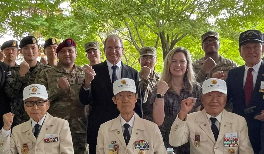 John Singlaub and Dayne Weber join soldiers from U.S. Forces Korea, the Korean Special Forces, and Korean War veterans, to memorialize, respectively, their father and grandfather. (Andrew Salmon/The Washington Times)