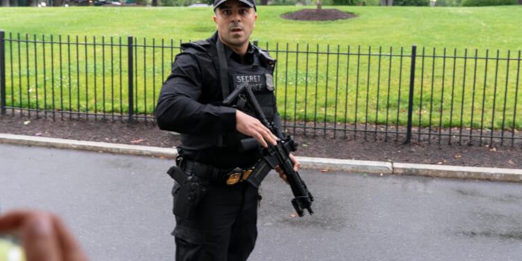 A Secret Service officer prevents journalists from leaving the White House on May 23, 2026.