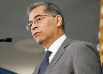 Xavier Becerra stands at a podium.