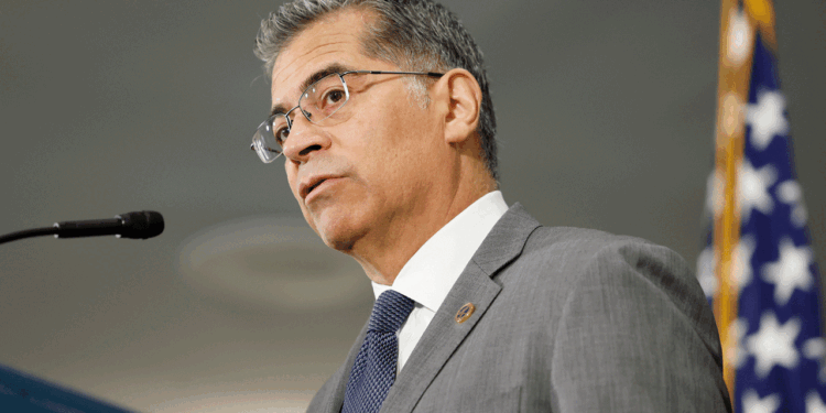 Xavier Becerra stands at a podium.