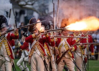 Revolutionary War reenactors firing guns