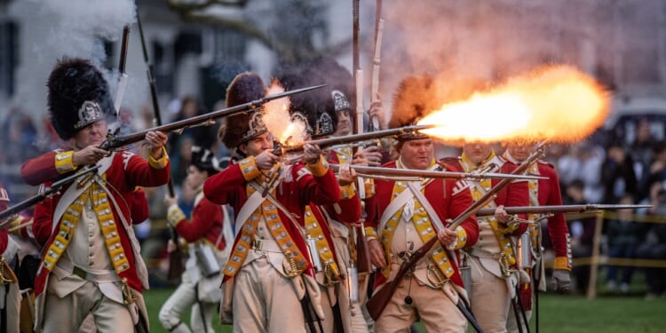 Revolutionary War reenactors firing guns