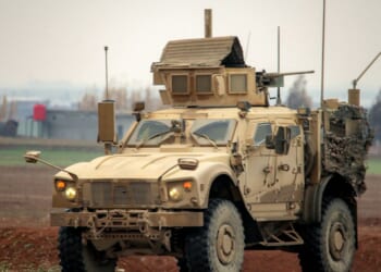 A U.S. military mine-resistant ambush protected vehicle moves along a road in a convoy transporting Islamic State group detainees being transferred to Iraq from Syria, on the outskirts of Qahtaniyah in Syria's northeastern Hasakah province on Feb. 7, 2026.