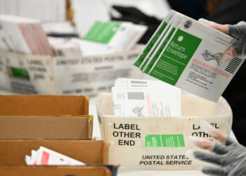 Election workers process mail-in ballots at the Los Angeles County Ballot Processing Center during California's state primary election in the City of Industry, California, on June 2, 2026.