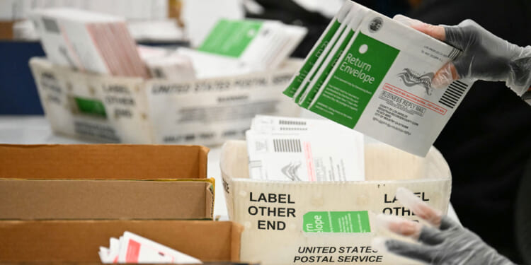 Election workers process mail-in ballots at the Los Angeles County Ballot Processing Center during California's state primary election in the City of Industry, California, on June 2, 2026.