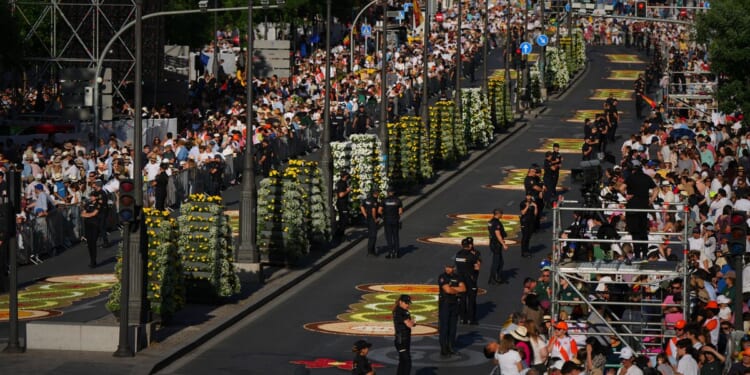 1 million people flood Madrid streets to see the pope’s flower-carpeted procession