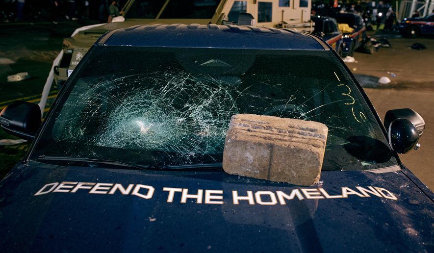 A brick sits on the hood of a damaged Department of Homeland Security vehicle outside the Delaney Hall detention center following a protest Friday, May 29, 2026, in Newark, N.J. (AP Photo/Andres Kudacki)