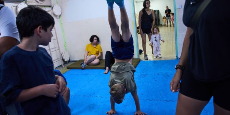 After morning of sirens, Israelis fall back into well-worn war routines