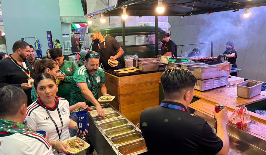 Fans attending the World Cup soccer game between Mexico and South Korea in Zapopan, near Guadalajara, Mexico, Thursday, June 18, 2026, buy food at a concession stand inside Guadalajara Stadium. (AP Photo/Tales Azzoni)