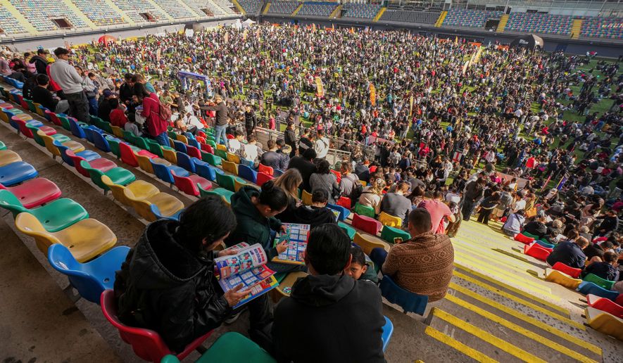 Soccer fans gather to trade Panini World Cup sticker albums and trading cards at the Bicentenario de La Florida stadium in Santiago, Chile, Sunday, May 31, 2026. (AP Photo/Esteban Felix)
