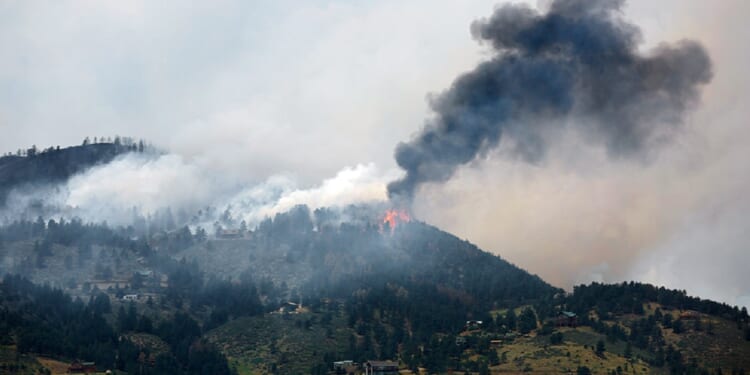 Smoke fills a mountain sky in a file photo from a 2012 wildfire in Colorado.