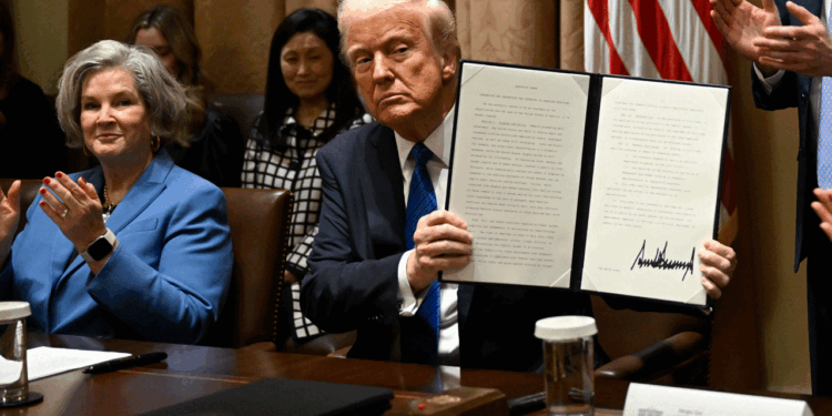 President Donald Trump, center, shows off a signed executive order with his Chief of Staff Susan Wiles, left, and Director of Presidential Personnel Sergio Gor, right, during a meeting with ambassador nominees in the Cabinet Room at the White House in Washington, DC on March 25, 2025. (Photo by John McDonnell/For The Washington Post via Getty Images)