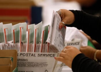 An election worker processes mail-in ballots for the California state primary election at the Los Angeles County Ballot Processing Center on June 5, 2026, in City of Industry, California.