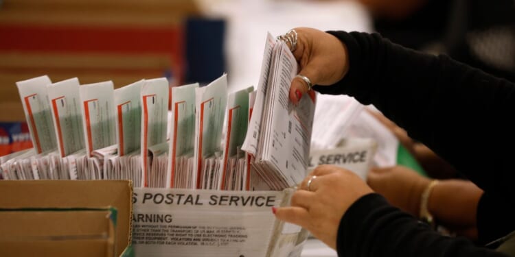 An election worker processes mail-in ballots for the California state primary election at the Los Angeles County Ballot Processing Center on June 5, 2026, in City of Industry, California.