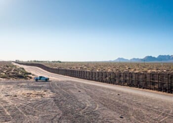 A border patrol vehicle stands parked near the U.S.-Mexico border on a sunny day in El Paso, Texas.