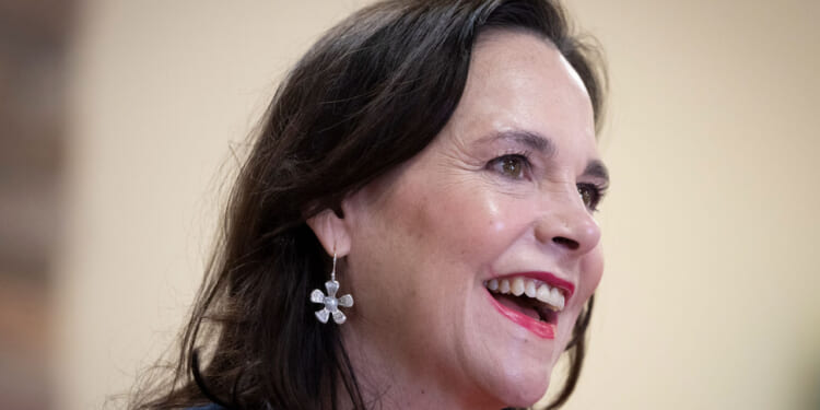 Jane Timken looks to the side and smiles.