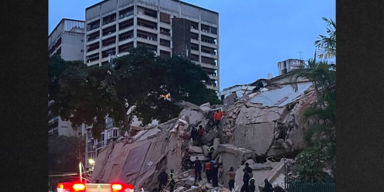 Rescuers search for victims in a collapsed building following an earthquake in Caracas Wednesday evening. A magnitude 7.1 earthquake struck Venezuela on Wednesday, the United States Geological Survey reported, triggering panic in Caracas, according to AFP journalists.