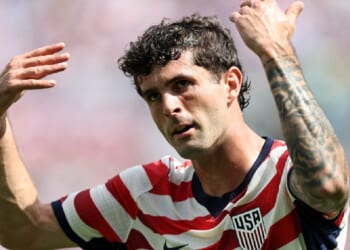 Christian Pulisic of the United States Men's National Soccer Team gestures with both arms raised during the international friendly match between United States and Senegal on Sunday at Bank of America Stadium in Charlotte, North Carolina.