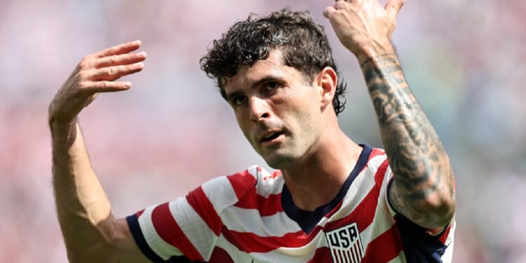 Christian Pulisic of the United States Men's National Soccer Team gestures with both arms raised during the international friendly match between United States and Senegal on Sunday at Bank of America Stadium in Charlotte, North Carolina.