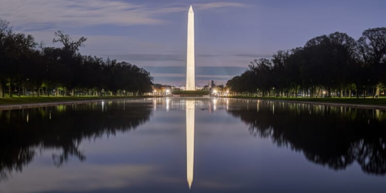 The Washington Monument is reflected in the National Mall's Reflecting Pool in an April 2025 twilight photo.