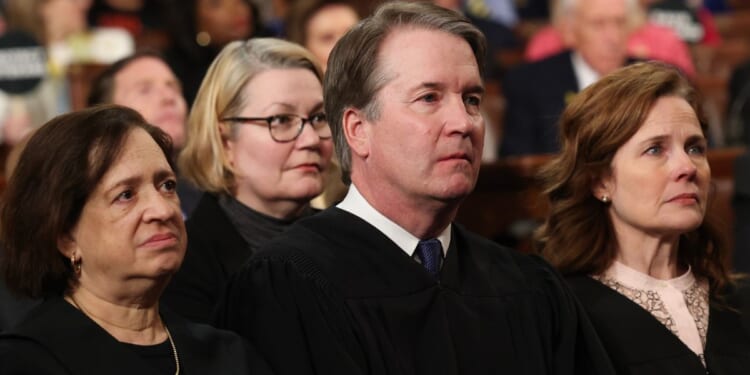 Supreme Court Chief Justice John Roberts, center, was joined by Supreme Court Justices Elena Kagan, left, and Amy Coney Barrett, right, along with Kagan's fellow liberals, Sonia Sotomayor and Ketanji Brown-Jackson, on the ruling.