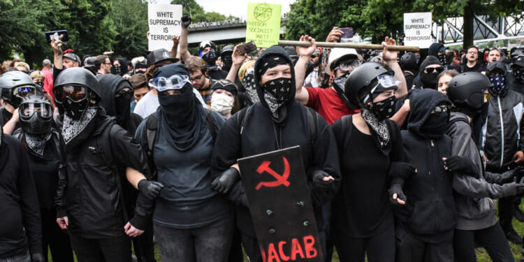 Members of Antifa line up during an alt-right rally on August 17, 2019 in Portland, Oregon.