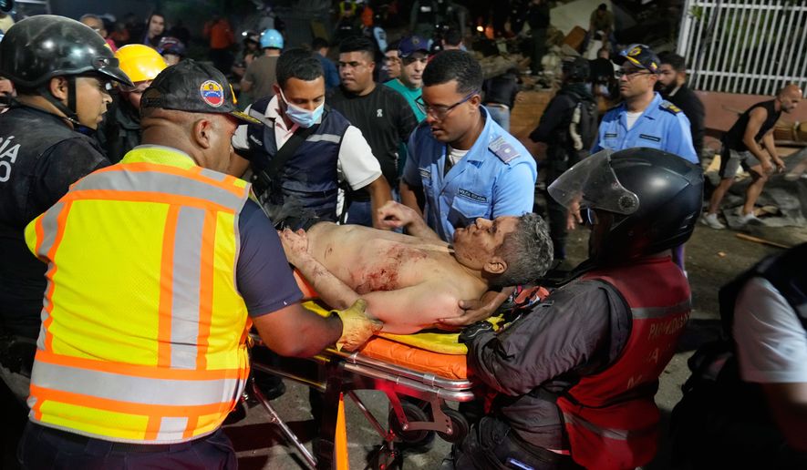 Rescue worker carry an injured man after an earthquake in Caracas, Venezuela, Wednesday, June 24, 2026. (AP Photo/Ariana Cubillos)
