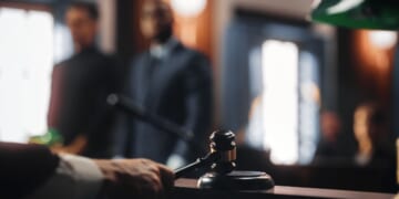 A judge strikes with his gavel in a courtroom.