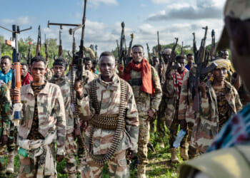 Soldiers of the Somalia National Army (SNA) raise their weapons when they gathered near their camp for a talk from visiting senior officers at Awdheegle, one of several towns recently liberated from the Al-Qaeda-linked militants, Al-Shabaab.