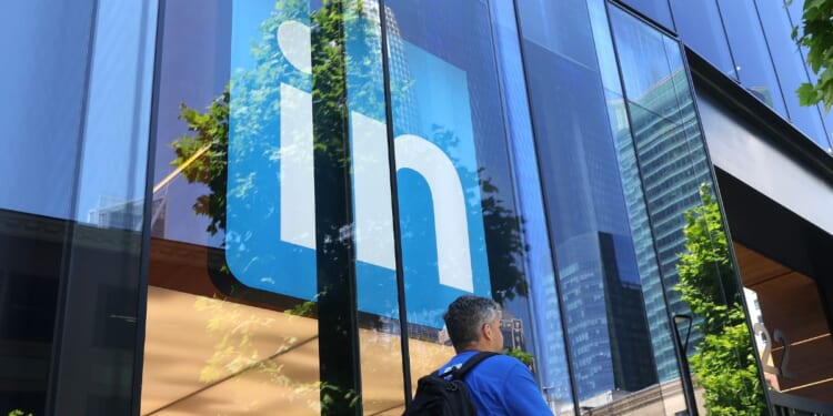 A pedestrian walks by a sign at a LinkedIn office on July 26, 2023, in San Francisco, California.